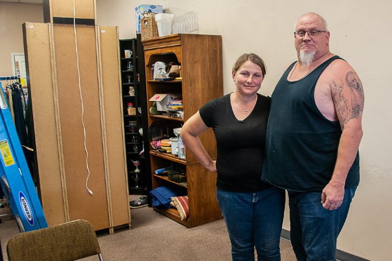 Owner Ildiko Carpenter stands with her husband inside her thrift shop, Kelsee's Purse. // M. Hazlip