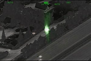 A suspect in a vehicle can be seen pointing a green laser at an aircraft in this still frame from a CHP video released Aug. 20.
