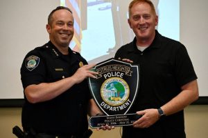 Citrus Heights Police Chief Alex Turcotte stands with Corporal Brian Barron holding a plague that reads 'Brian Barron, Police Corporal: April 26, 2006 - May 31, 2025. // Citrus Heights Police Department.