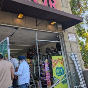 Several men were seen installing a new door at Empire Liquor after a stolen vehicle crashed through the entrance early in the morning, Sept. 22, 2025.